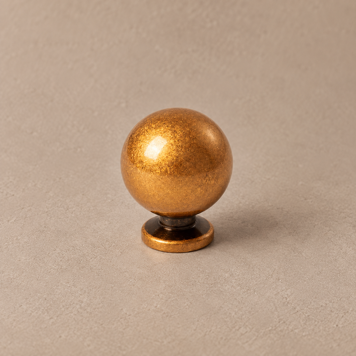 Warm antique brass ball cabinet knob detail
