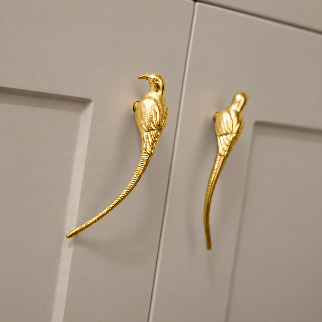 Polished Brass Bird-Design Cabinet Handle — Decorative Accent on a neutral stone studio background