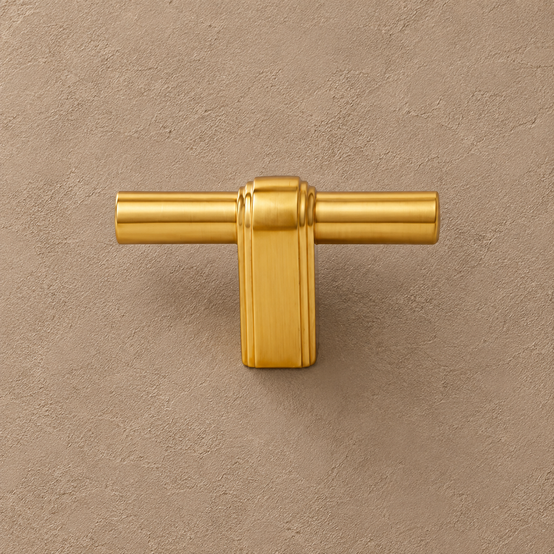 Polished Brass Cabinet Pulls & T-Knob — Modern Luxury Design on a neutral stone studio background