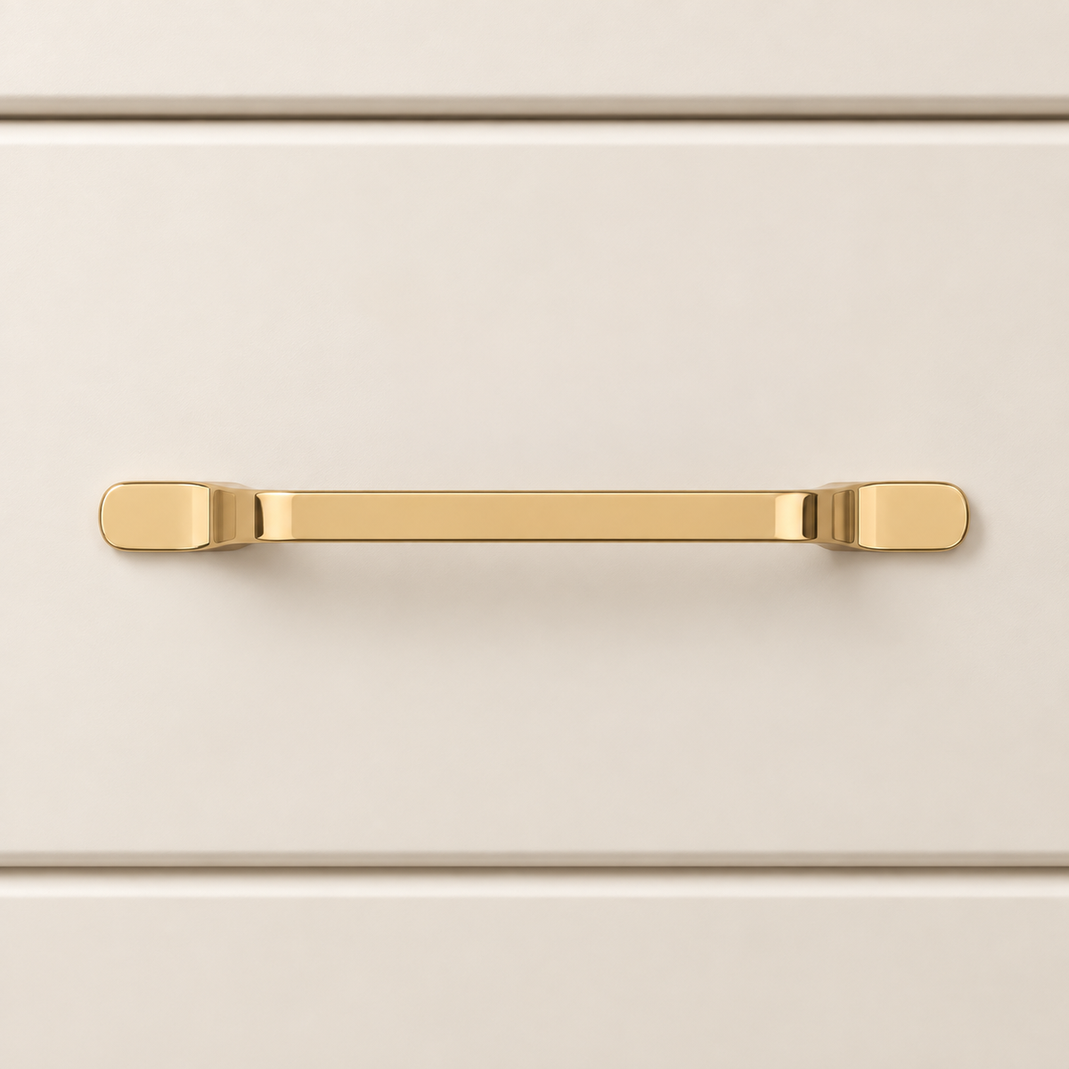 Polished gold offset cabinet pull mounted flush on a cream drawer