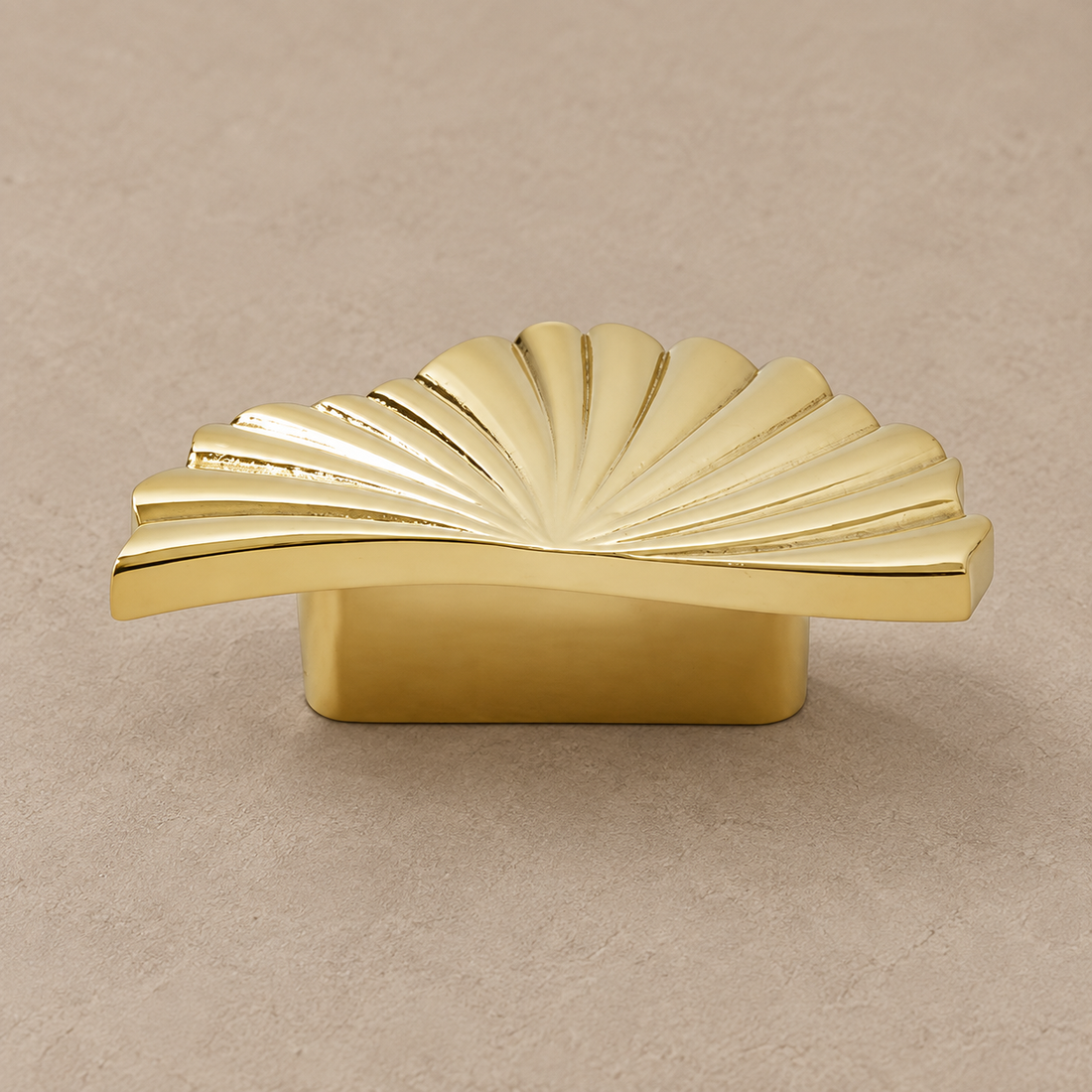 Nordic Ruffled Brass Cabinet Handle & Knob on a deep olive studio background