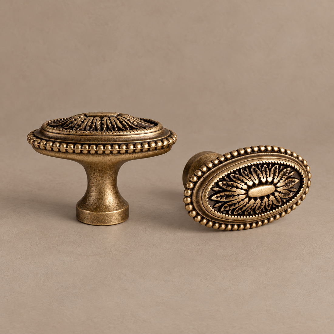 Tapered Spindle Cabinet Pull & Knob — Antique Brass on a neutral stone studio background