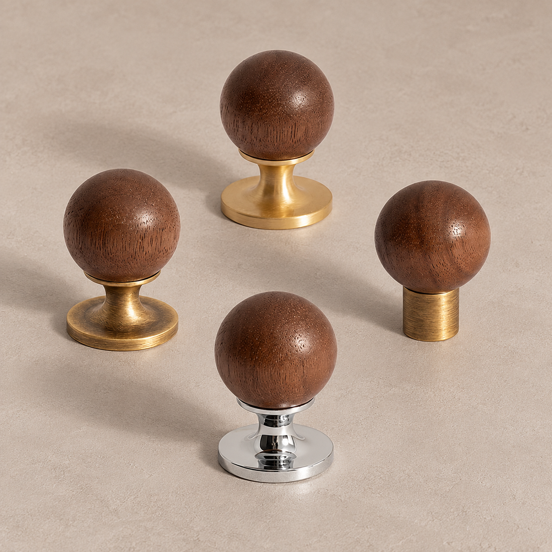 Walnut ball cabinet knobs with brass and chrome bases in a premium studio setting