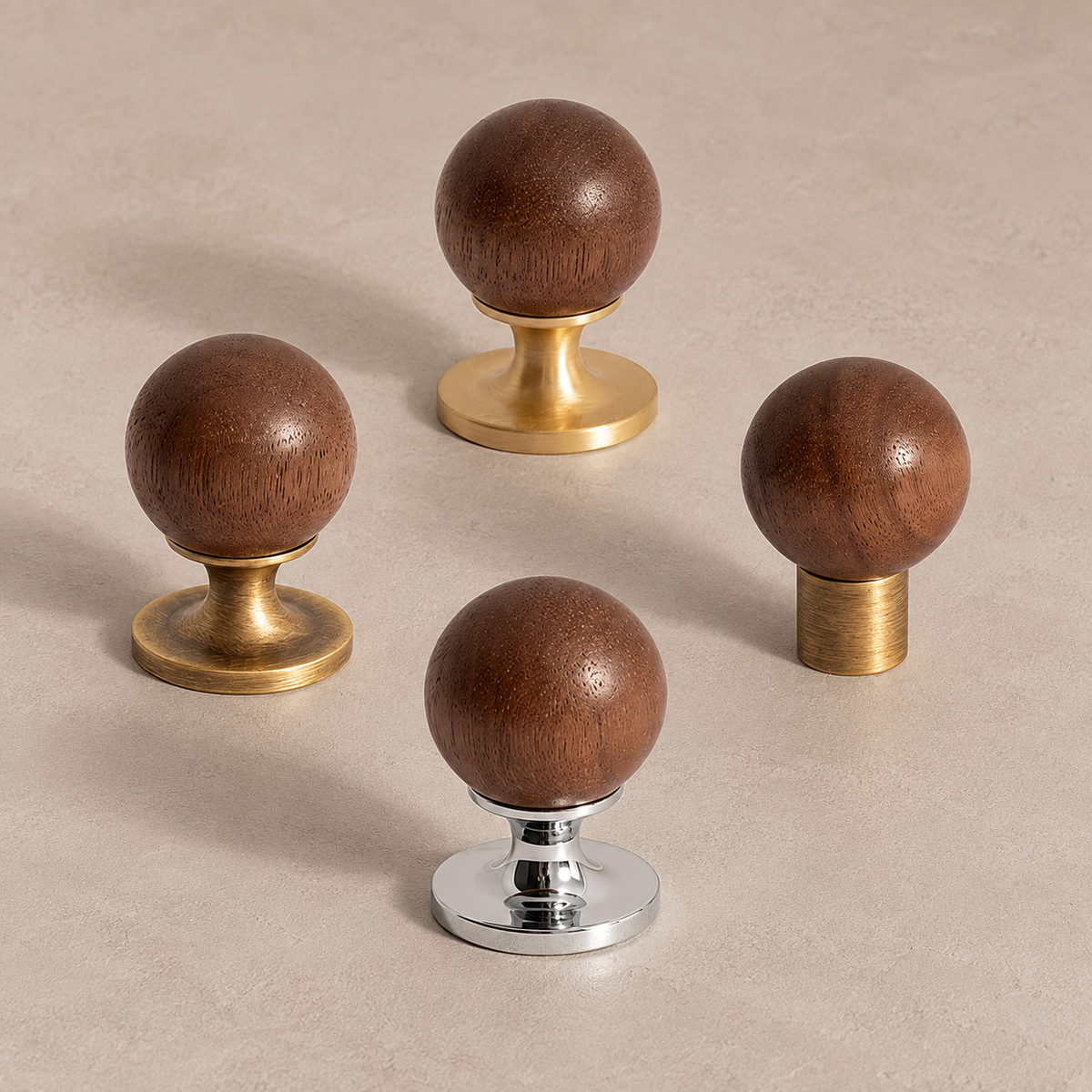 Walnut ball cabinet knobs with brass and chrome bases in a premium studio setting