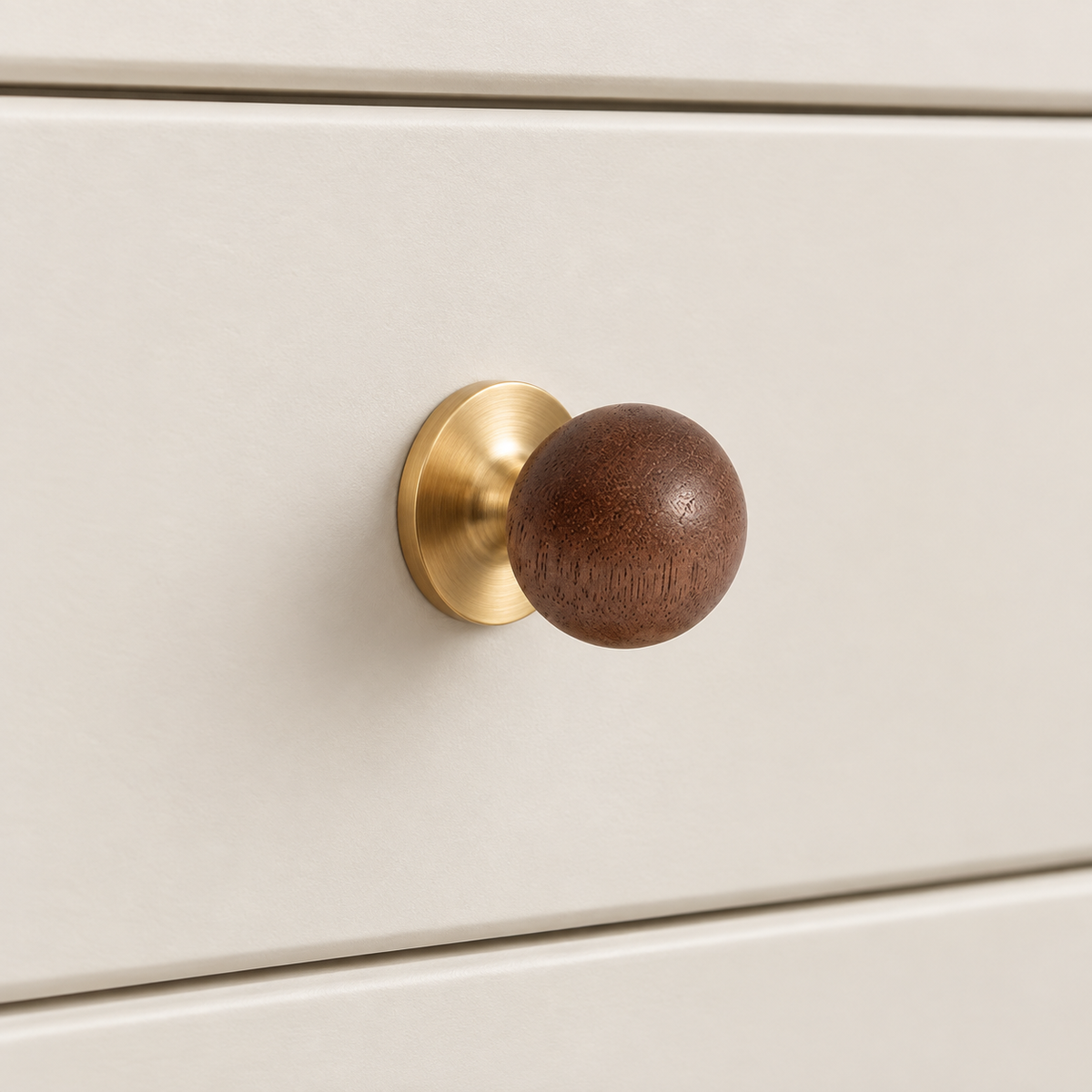 Walnut ball cabinet knobs with brass and chrome bases in a premium studio setting